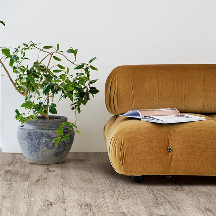 Modern interior with Pergo Arendal Grey Barnhouse laminate flooring featuring cool grey planks and a natural wood grain for a clean, rustic-contemporary style.