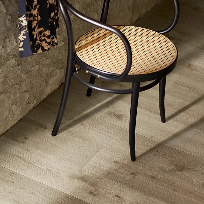 Stylish interior featuring Pergo Arendal Meadow laminate flooring with light golden wood tones that create a bright and welcoming atmosphere.