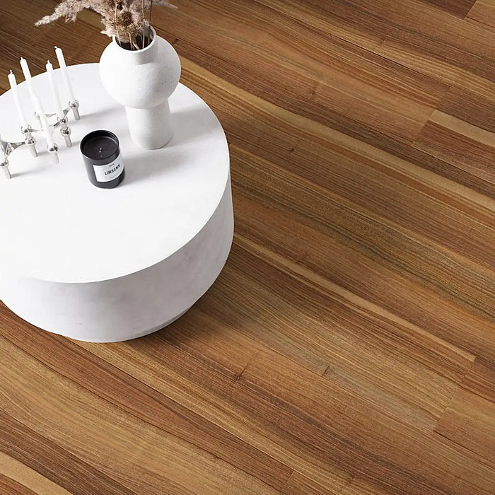 A warm, traditional interior featuring Pergo Arendal Refined Walnut laminate flooring with long planks and a classic wood grain design.