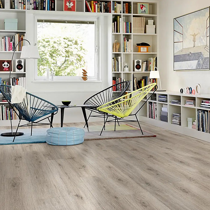 Drammen Dartmoor laminate flooring in a cosy, modern room setting with warm brown tones and realistic oak wood pattern.