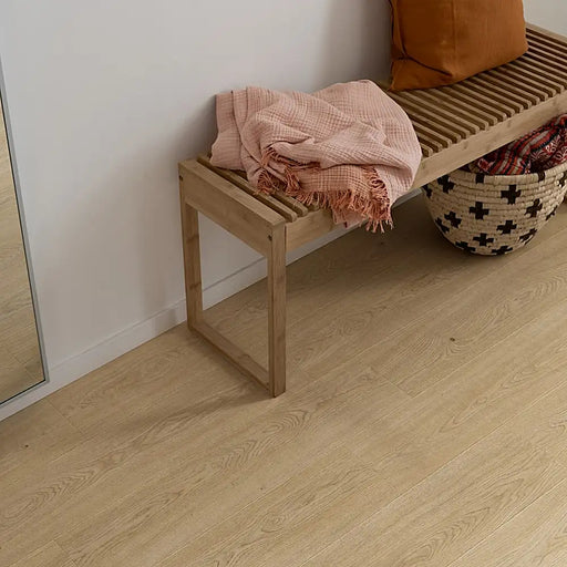 Drammen Isla beige laminate flooring in a bright living space, showing natural wood tones and soft bevelled planks for a clean, airy look.