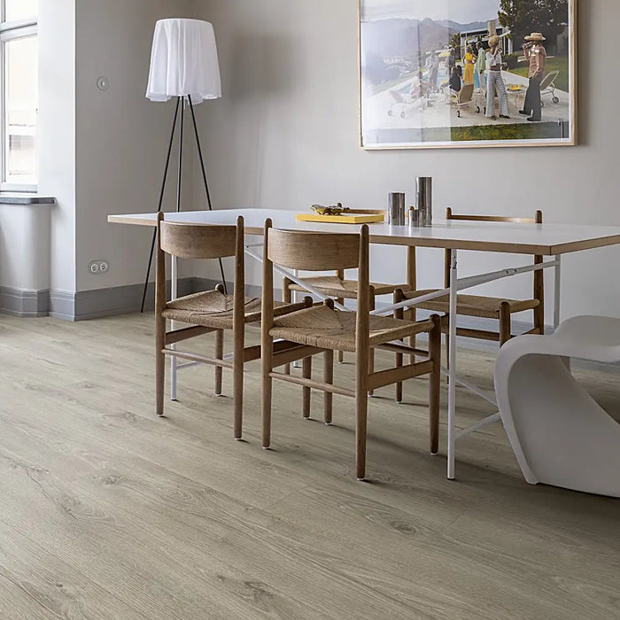 Minimalist dining room with Pergo Glomma Grey Eifel LVT flooring and bright natural light.
