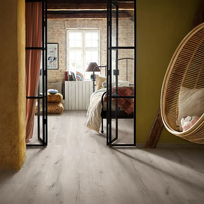 Bedroom with Pergo Glomma White Scottish LVT flooring and bright natural light.