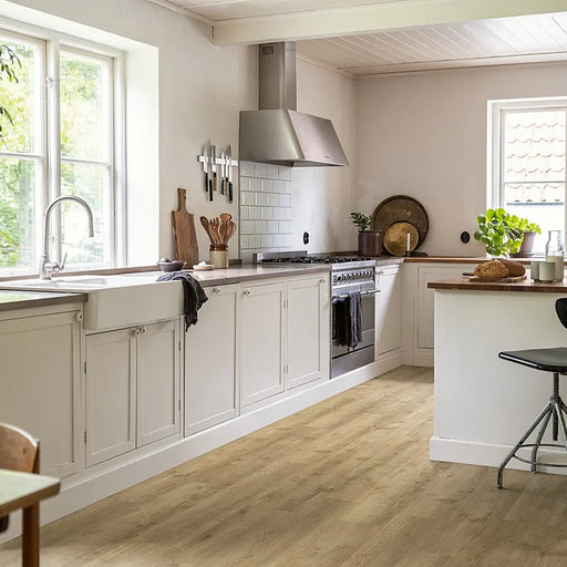 A cosy kitchen featuring Pergo Namsen Beige Century LVT with warm beige oak tones and authentic wood detail.