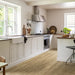 A cosy kitchen featuring Pergo Namsen Beige Century LVT with warm beige oak tones and authentic wood detail.