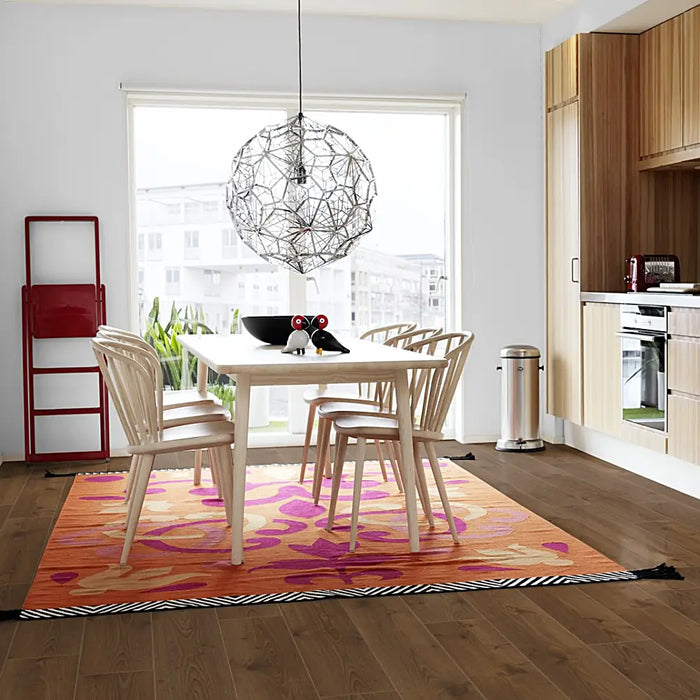 Elegant dining room with Pergo Namsen Dark Lakeland LVT in rich dark oak tones.