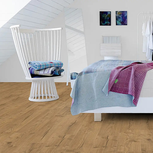 Bright bedroom with Pergo Namsen Light Cabin LVT in pale oak tones.