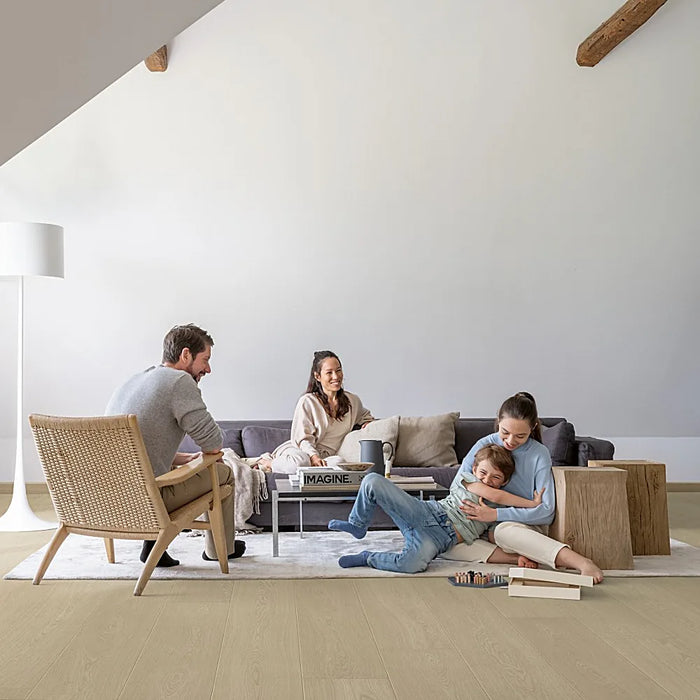 Modern living space featuring Pergo Odense Clay laminate flooring in rich taupe, paired with soft furnishings and natural accents.