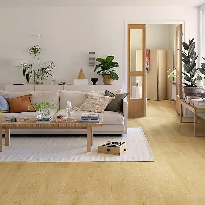Bright interior space featuring Pergo Odense Clear laminate flooring with light beige tones and wide planks that enhance the room’s openness.