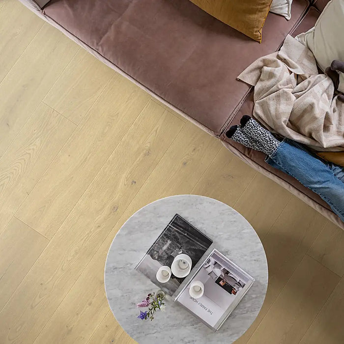 Modern living space with Pergo Odense Clouded laminate flooring in a cool grey tone, featuring extra-wide planks and a clean, elegant finish.