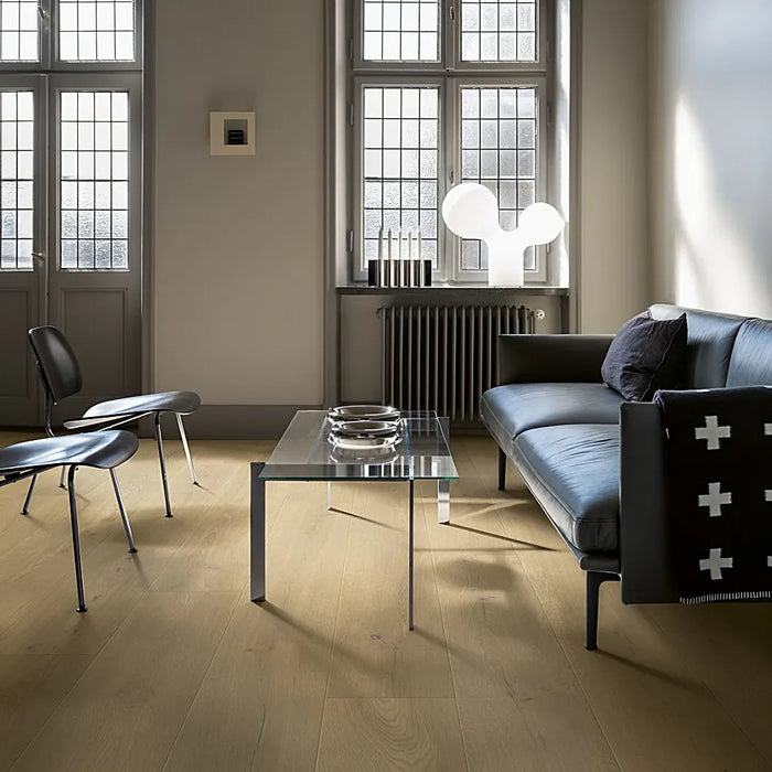 Modern living space with Pergo Odense Clouded laminate flooring in a cool grey tone, featuring extra-wide planks and a clean, elegant finish.