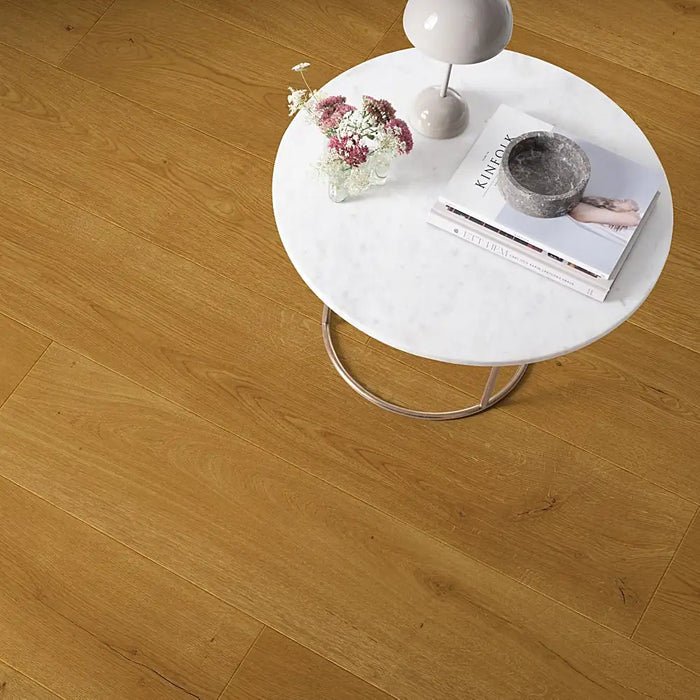 Modern interior with Pergo Odense Dusk laminate flooring in dark grey shades, featuring extra-long, wide planks and a matte woodgrain texture.