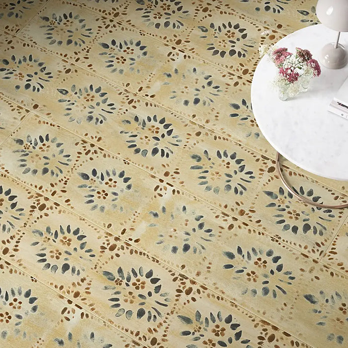 Living room with Pergo Odense Folk laminate flooring in warm mid-brown tones, showing extra-wide planks and a natural wood finish.