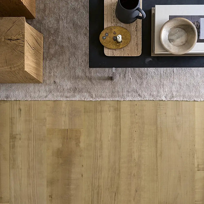 Cosy living space with Pergo Odense Rustic Charm laminate flooring in warm brown hues, wide planks, and natural woodgrain detail.