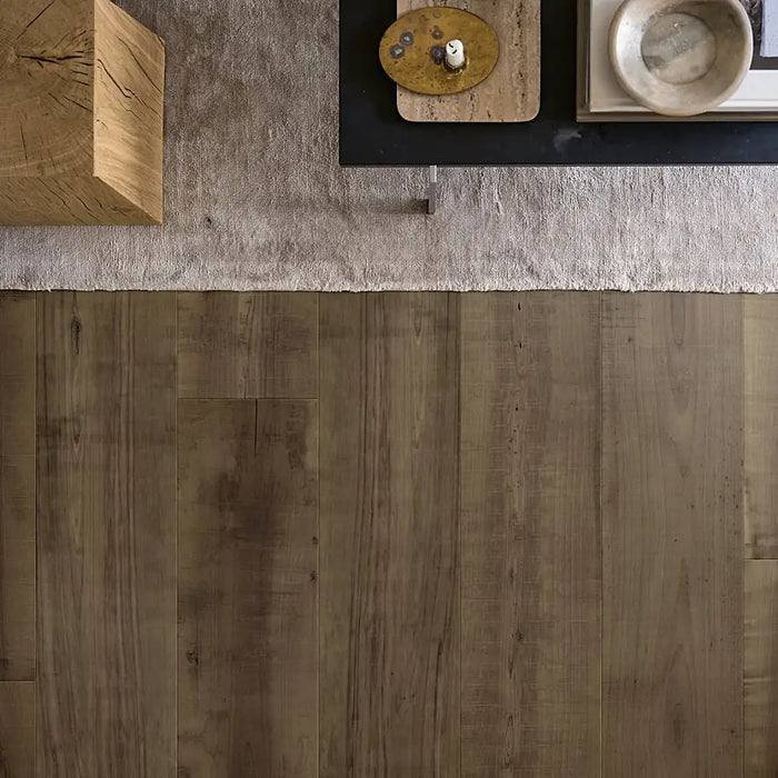 Spacious living room featuring Pergo Odense Rustic Smoke laminate flooring with rich dark tones, wide plank format, and a natural wood grain finish.
