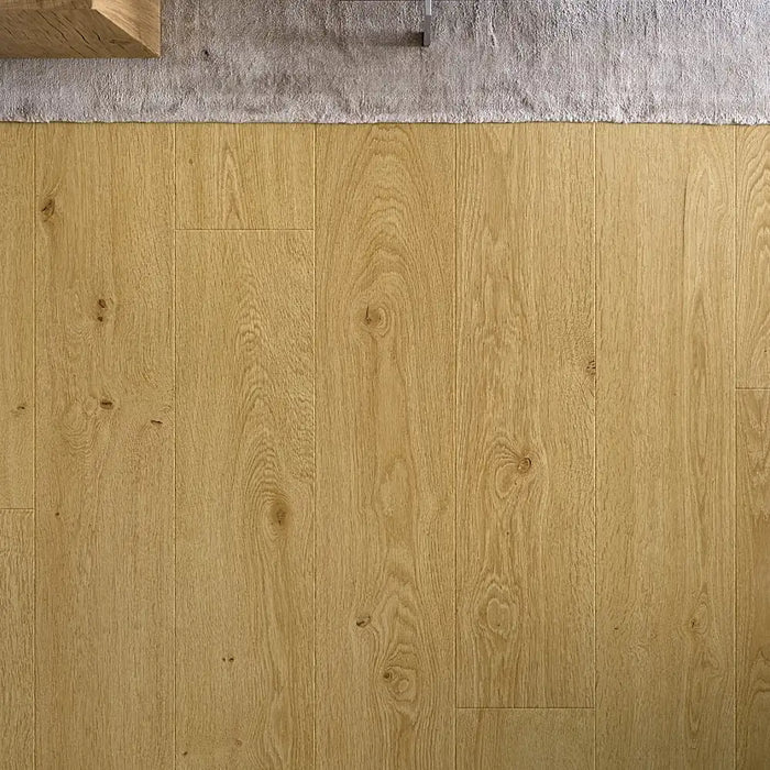 Modern interior with Pergo Odense Vibrant laminate flooring in golden brown, featuring extra-long, wide planks and realistic wood detailing.