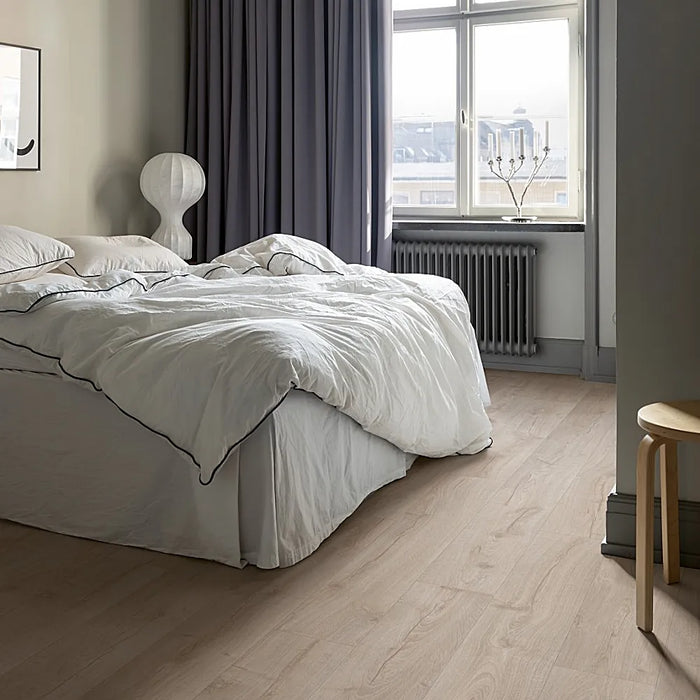 Pergo Visby Urban Grey laminate flooring in a modern living space with sleek, cool-toned grey planks and a clean, urban aesthetic.