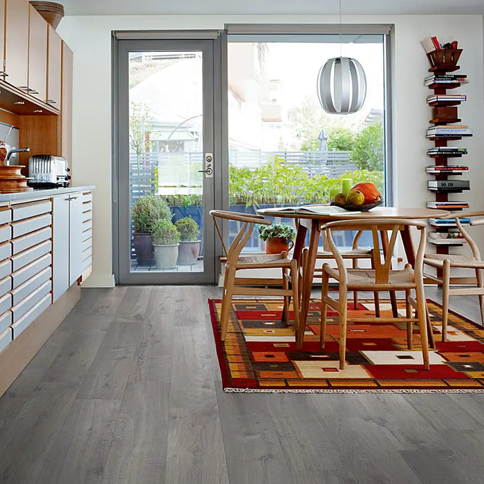 Pergo Visby Urban Grey laminate flooring in a modern living space with sleek, cool-toned grey planks and a clean, urban aesthetic.