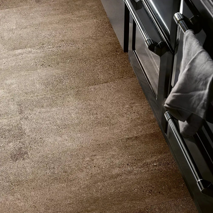 Kitchen with Pergo Viskan Wet Sandstone flooring, showing warm beige stone-like tones.