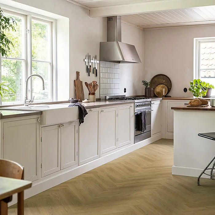 Beige Norwegian herringbone LVT flooring in a Scandinavian-style kichen.