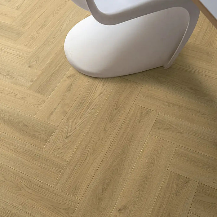 Detail of Beige Norwegian herringbone LVT plank with soft beige tones and fine grain.