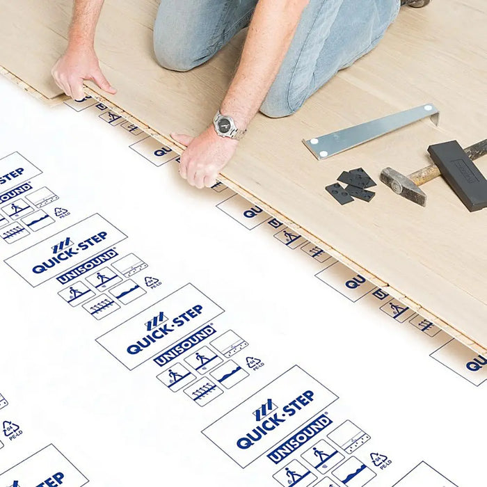 Quick-Step Unisound Underlay unrolled over a subfloor, with laminate boards ready for fitting.