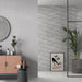 Bathroom wall styled with RLV Persa Gris 33.3x55 wall tiles, showcasing a decorative grey relief finish.