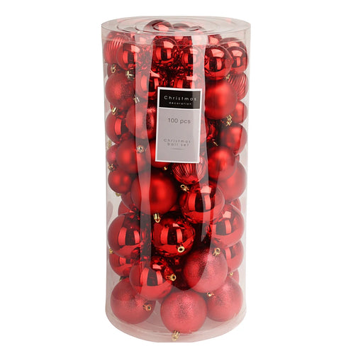 Close-up of assorted red baubles showing shiny, matt, and textured surfaces.