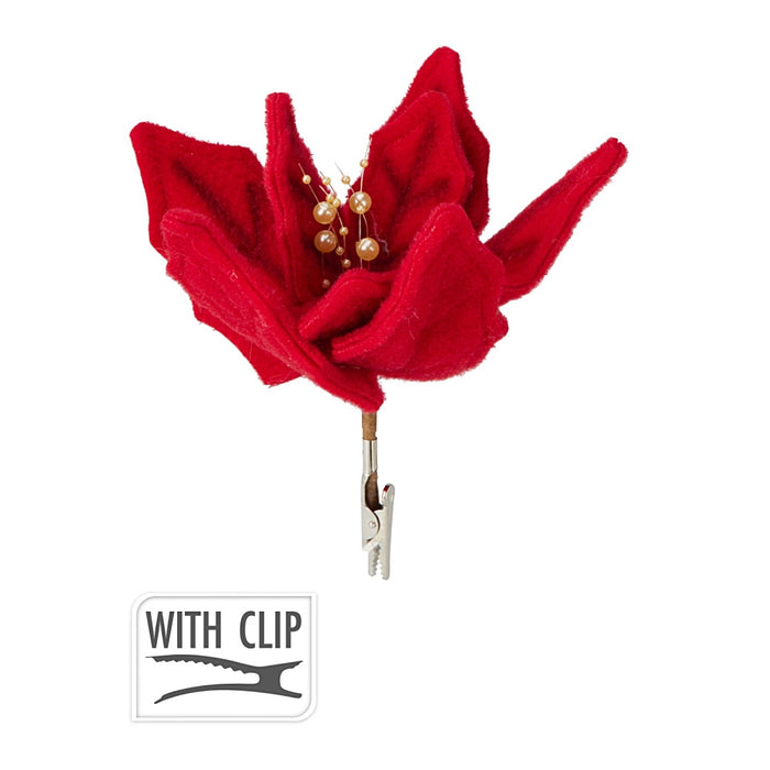 Close-up of red flower decoration showing glittery petals and metal clip.