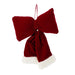 Close-up of red plush bow showing soft texture and deep festive red colour.