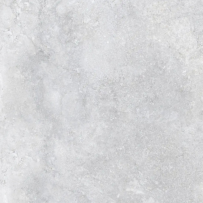 Detailed close-up of Roden Perla Natural porcelain tile showing its smooth matt surface and gentle grey tone.
