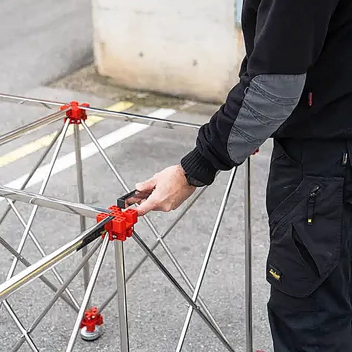 Rubi Retrac-Table fully assembled in a workspace, showcasing its 120x120cm surface and robust, professional-grade frame.