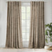 Scatter Box Caden Mulberry Green textured eyelet curtains with silver eyelets dressing a large window in a contemporary room