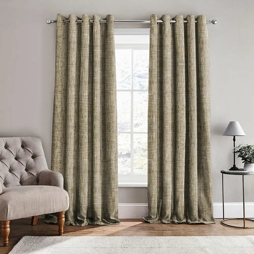 Scatter Box Caden Natural textured fully lined eyelet curtains hanging on a curtain pole in a neutral modern living space
