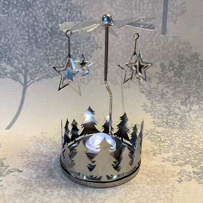 Close-up of silver star carousel tealight holder showing reflective star cutouts in motion.