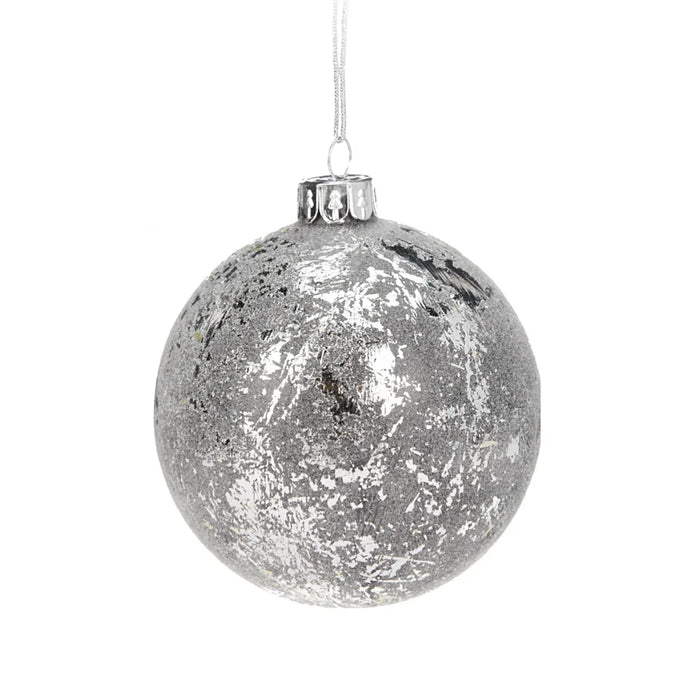 Close-up of silver textured Christmas bauble showing detailed surface pattern and reflective finish.