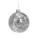 Close-up of silver textured Christmas bauble showing detailed surface pattern and reflective finish.