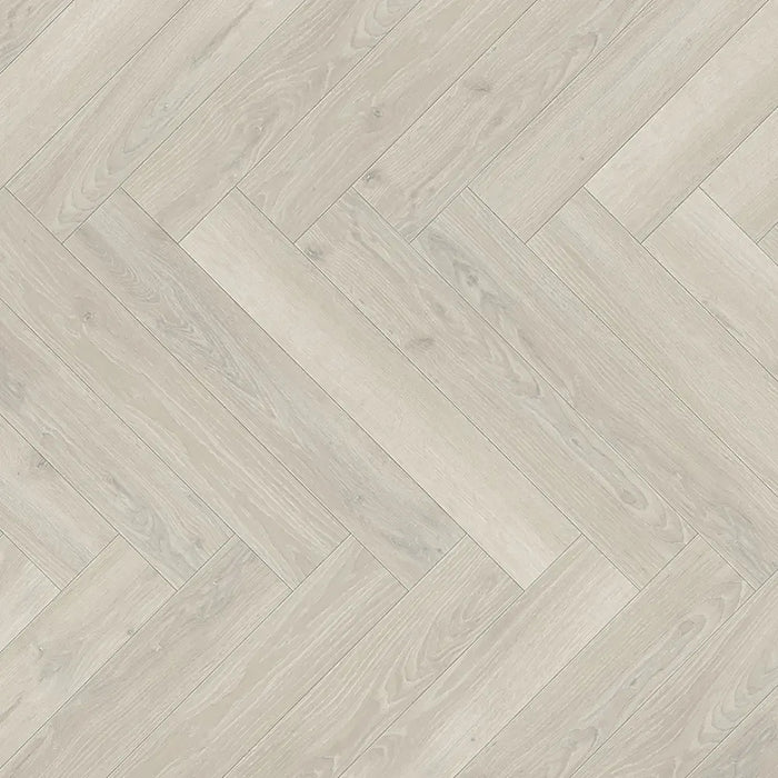 Close-up of Skyline White Herringbone laminate plank highlighting its natural matt surface, light oak texture, and realistic woodgrain detail.