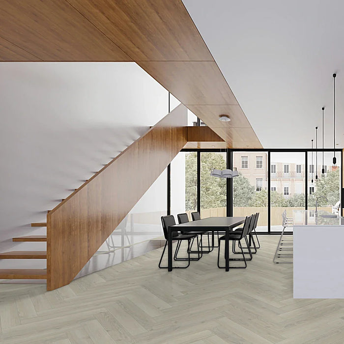 Skyline White Herringbone laminate flooring styled in a bright, modern room, showcasing its soft white oak tones and elegant herringbone layout.