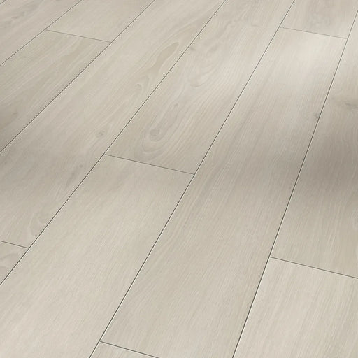 Close-up of Parador Skyline White laminate flooring, highlighting the natural oak grain and soft white tone with a matt textured finish.