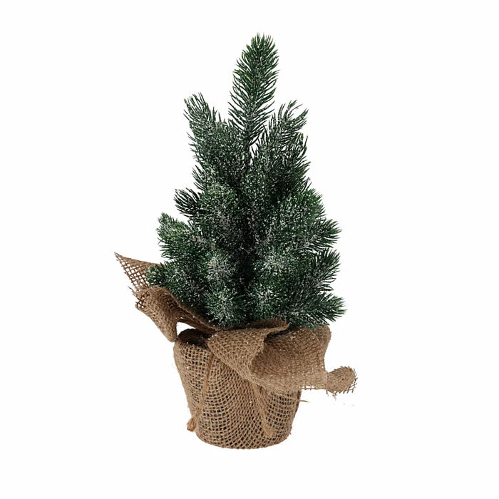 Close-up of snowy Christmas tree branches in a burlap pot showing white frosted tips and natural jute texture.