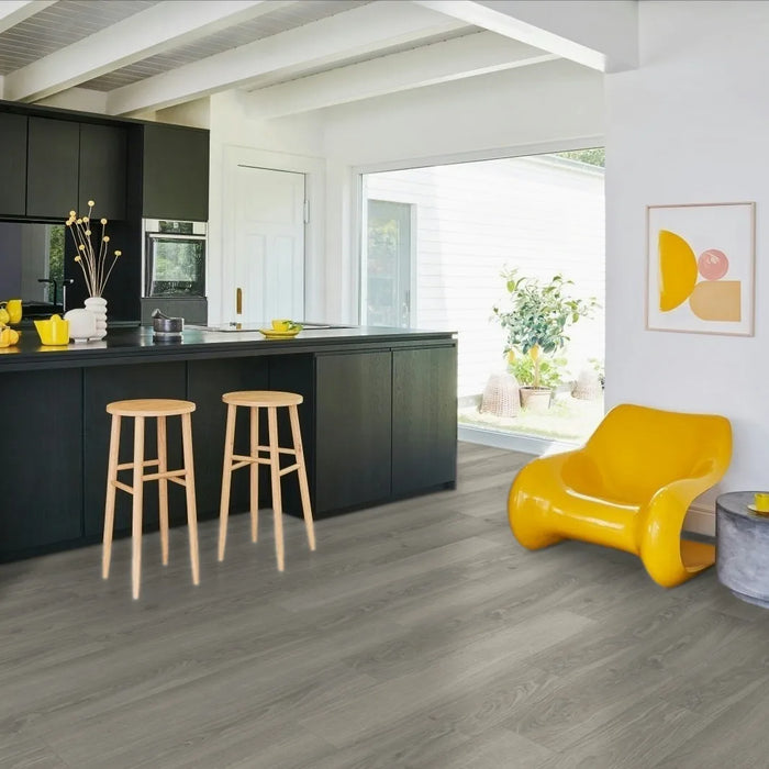 Room view featuring Parador Studioline Light-Grey laminate flooring installed, highlighting the wide plank format and neutral grey tone in a modern interior setting.