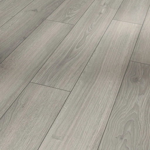 Close-up of Parador Studioline Light-Grey laminate flooring showing the natural matt wood texture and bevelled plank edge detail.