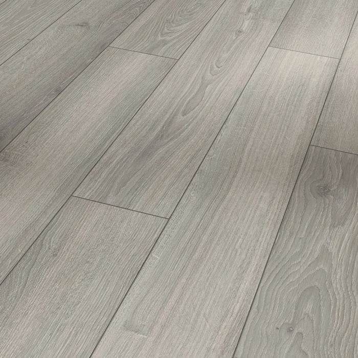 Close-up of Parador Studioline Light-Grey laminate flooring showing the natural matt wood texture and bevelled plank edge detail.