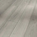 Close-up of Parador Studioline Light-Grey laminate flooring showing the natural matt wood texture and bevelled plank edge detail.