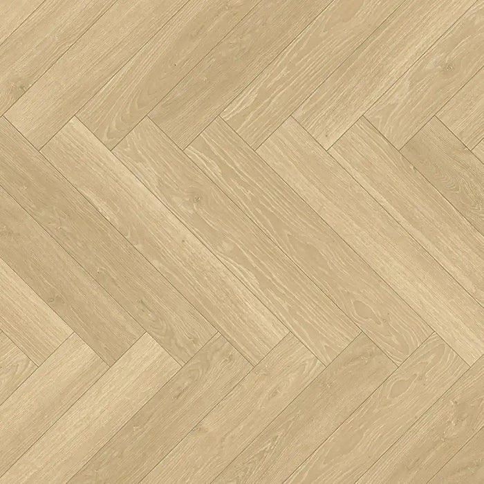 Close-up view of Studioline Natural Herringbone laminate showing its soft oak woodgrain detail and natural matt textured surface.