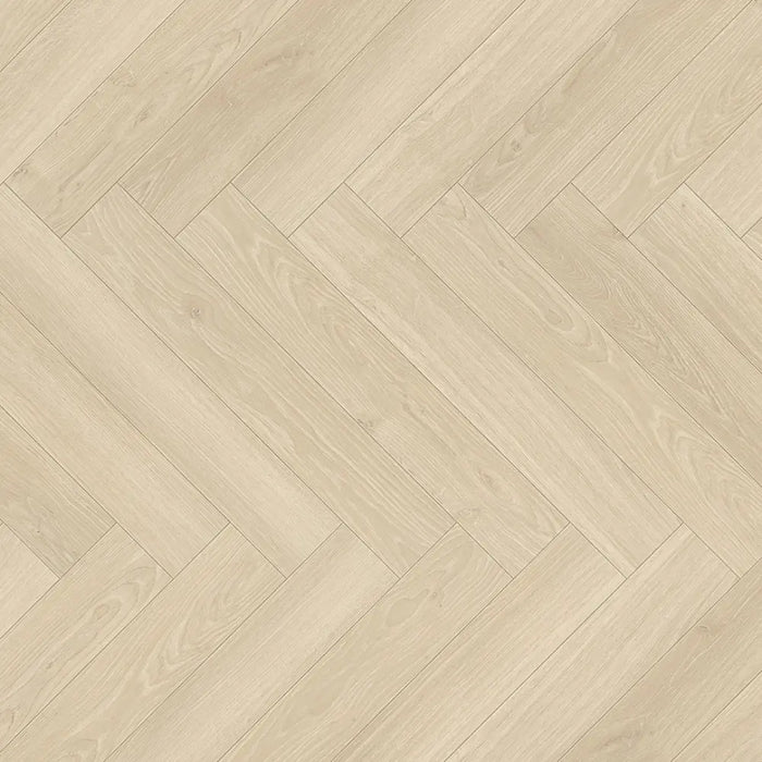 Detail of the Studioline Sanded Herringbone laminate showing the textured, natural matt finish and refined oak grain pattern.