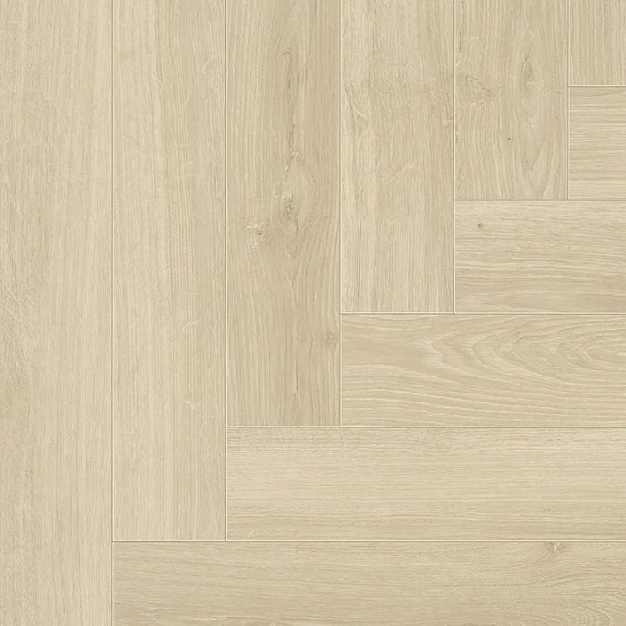 Detail of the Studioline Sanded Herringbone laminate showing the textured, natural matt finish and refined oak grain pattern.
