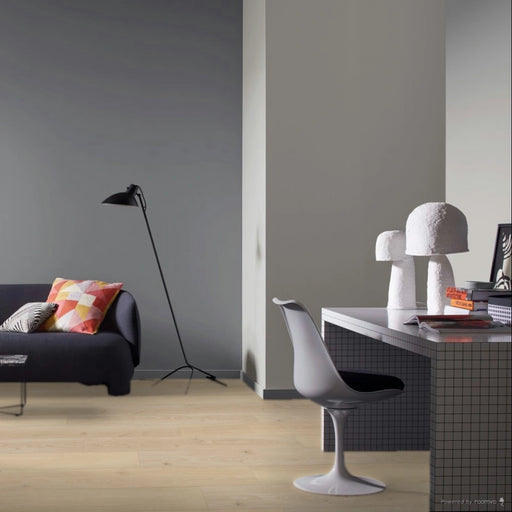 Set room image featuring Parador Studioline Sanded wide plank laminate, creating a warm and understated atmosphere in a modern interior.