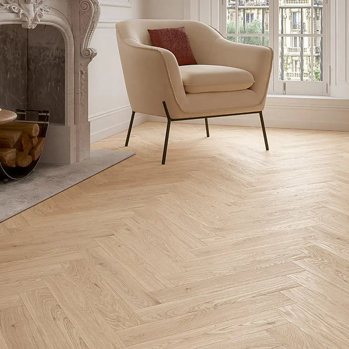 Detailed view of Bardolino White engineered herringbone plank showing the subtle whitewashed oak texture and clean bevel edges.